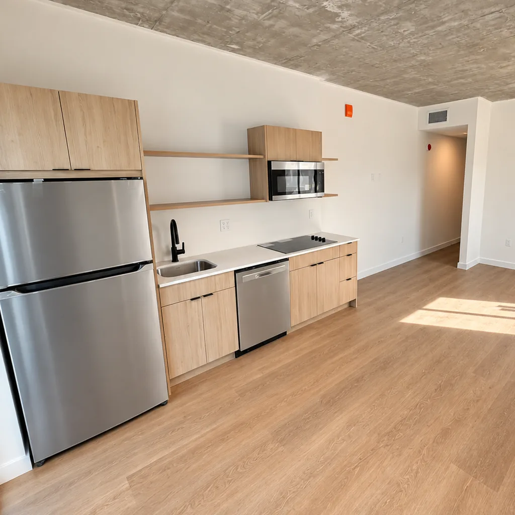 Studio kitchen with wood cabinetry and stainless appliances